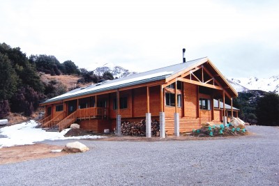 The Alistair Sidey Mountain Lodge captured with a small amount of snow at the front of the lodge as well as on the mountains behind the lodge.