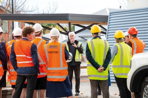 Students tour the new project mid-build.